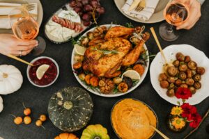 spread of holiday foods like turkey and pumpkins in dishes on a table